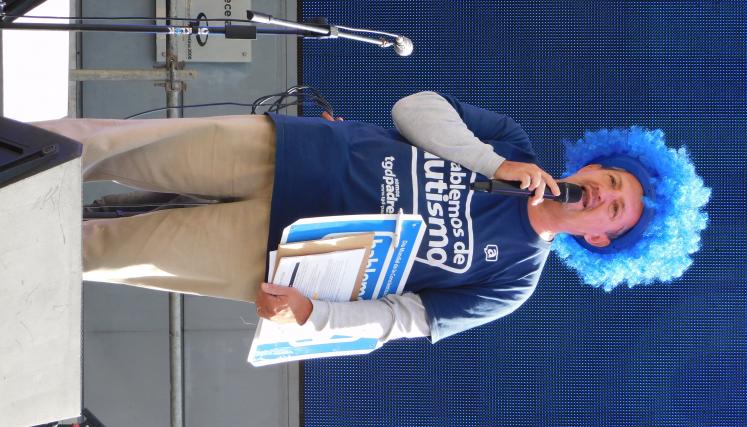 Padre de TGD con peluca color azul y microfono